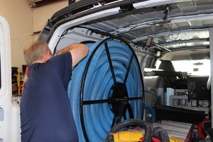 Flood Damage Restoration Technician Prepping Suction Hoses