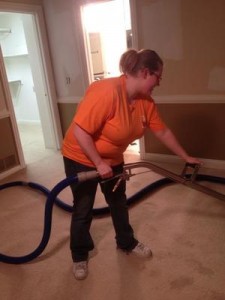 Water Damage Restoration Technician Vacuuming Up Water