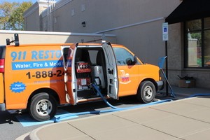 Water Damage Restoration Van AT Exterior Of Job Location